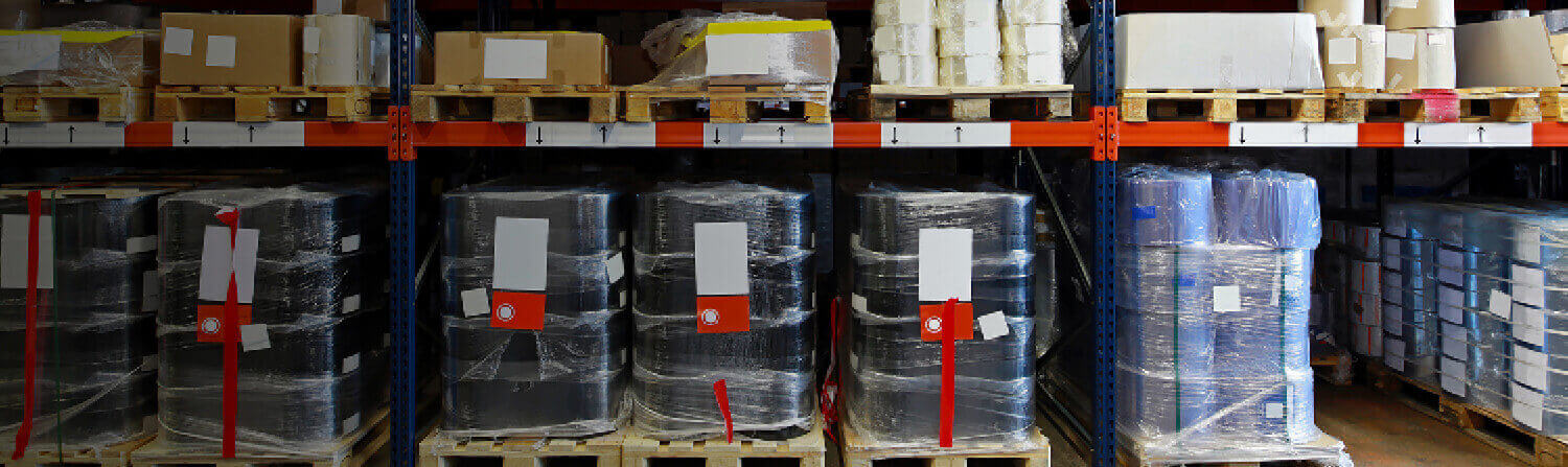 Barrels wrapped in plastic on warehouse shelves
