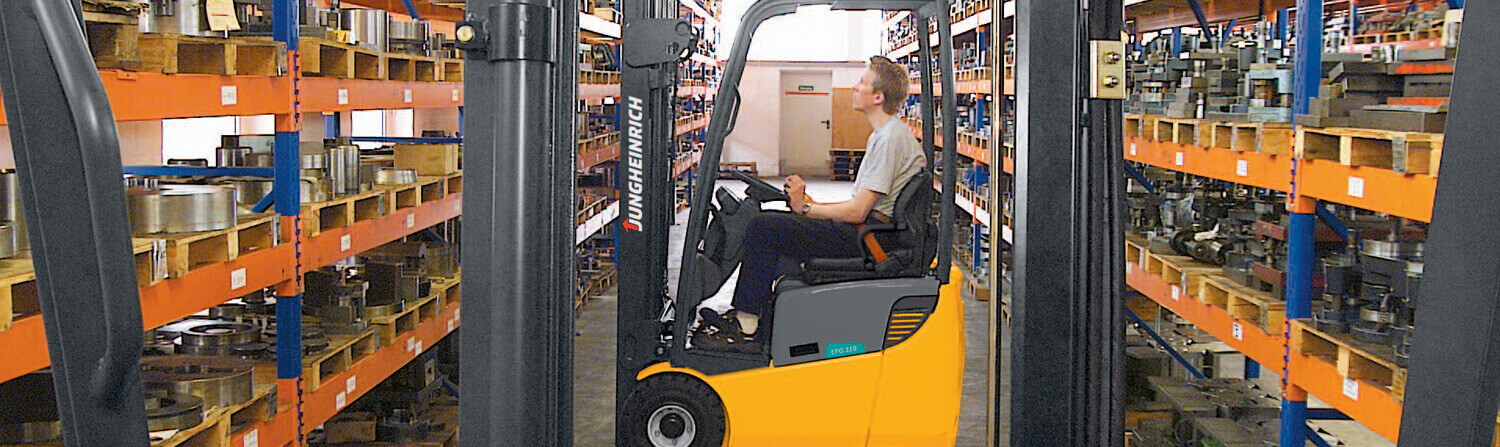 Side view of worker looking up while in Jungheinrich forklift