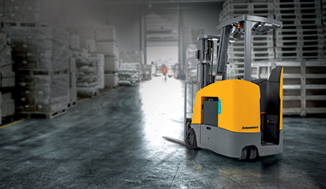 Jungheinrich stand-up counterbalanced lift truck in gray warehouse background