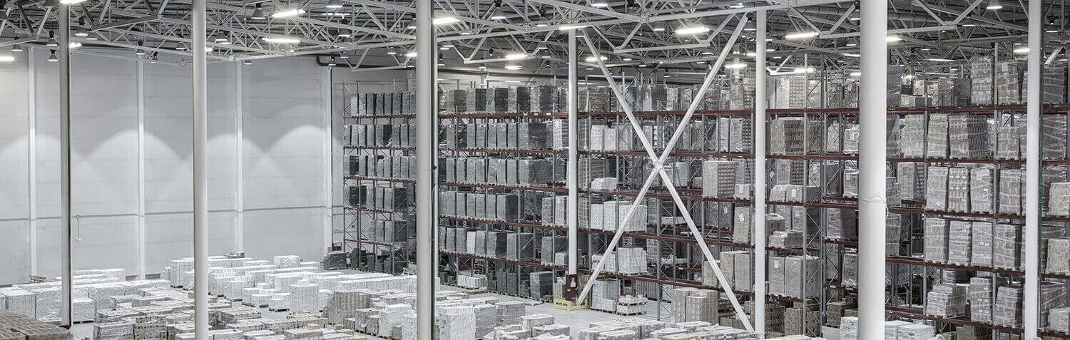 Gray toned warehouse background with shelves full of materials